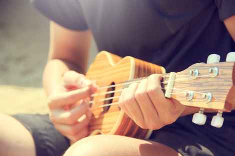 man ukulele string instrument stock photo