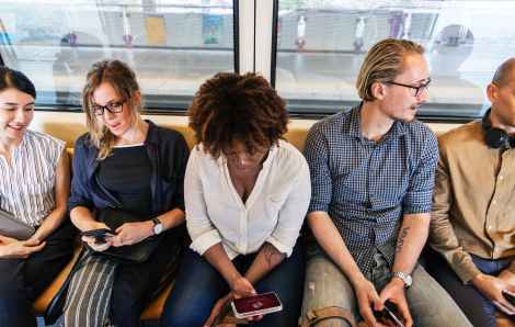 woman holding phone subway stock photo pexels